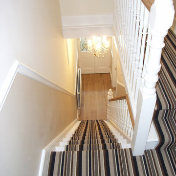 striped stair carpet leading to engineered oak hall floor