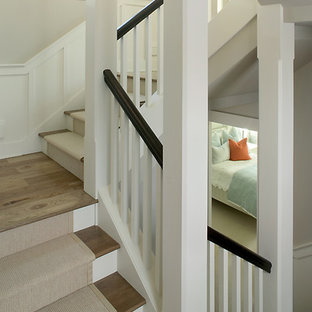 Example of a large transitional carpeted u-shaped staircase design in Grand Rapids with painted risers