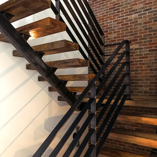 Esempio di una grande scala a "U" eclettica con pedata in legno, nessuna alzata e parapetto in metallo