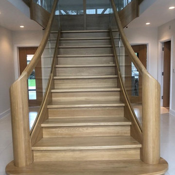 T shape Curved Oak staircase with glass balustrade