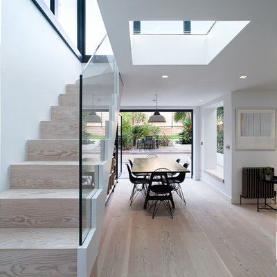 Example of a trendy wooden straight staircase design in London with wooden risers