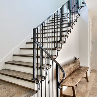 Staircase - transitional wooden metal railing staircase idea in Houston