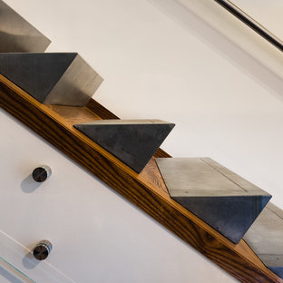 Inspiration for a mid-sized modern concrete l-shaped glass railing staircase remodel in Baltimore with wooden risers