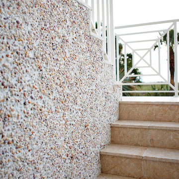 The Beachfront Milkey Back Stairway With Shell Themed Walls by Alvarez Homes