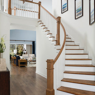 Example of a transitional wooden curved wood railing staircase design in Jacksonville with wooden risers