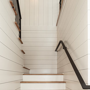 Esempio di una grande scala a "U" stile marinaro con pedata in legno, alzata in legno verniciato, parapetto in metallo e pareti in perlinato