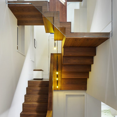 Example of a trendy wooden u-shaped staircase design in London with wooden risers