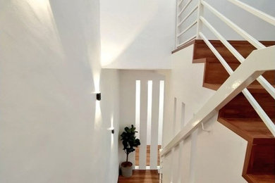 Design ideas for a medium sized scandi wood u-shaped metal railing staircase in Other with wood risers.