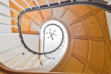 Inspiration for a large classic wood curved staircase in Seattle with wood risers.