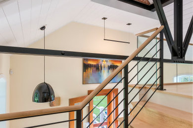 Example of a small urban wooden l-shaped metal railing staircase design in Other with wooden risers