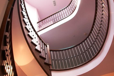 Large elegant curved staircase photo in Toronto