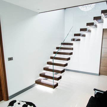 The walnut treads floating staircase with LED Lights