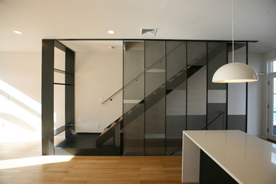 Design ideas for a medium sized modern wood straight metal railing staircase in Philadelphia with open risers.