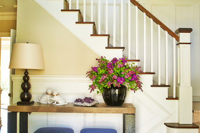 Example of a mid-sized classic wooden l-shaped staircase design in New York with painted risers