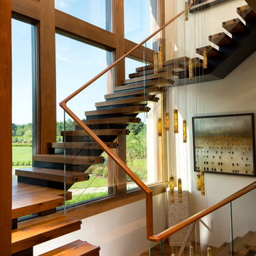 Three-story floating wood and steel entry staircase