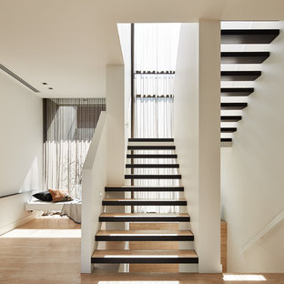 Design ideas for a contemporary wood u-shaped staircase in Melbourne with open risers.