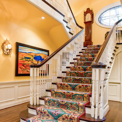 Large elegant wooden staircase photo in Toronto with wooden risers