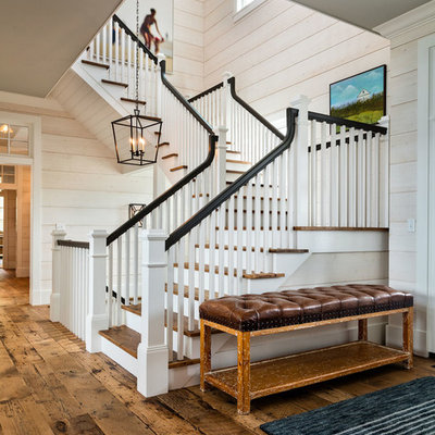Large cottage wooden u-shaped wood railing staircase photo in Milwaukee with painted risers