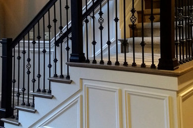 Staircase - mid-sized traditional carpeted l-shaped metal railing and wainscoting staircase idea in Seattle with wooden risers