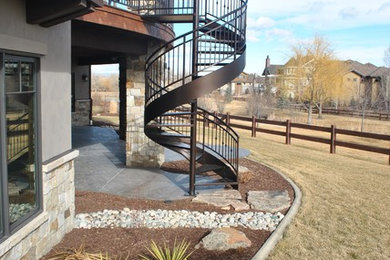 Example of a mid-sized classic metal spiral open and metal railing staircase design in Denver