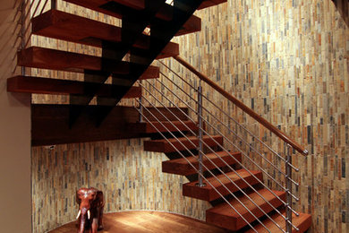 This is an example of a medium sized traditional wood l-shaped staircase in Houston with open risers.