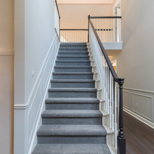 Inspiration for a large transitional carpeted straight staircase remodel in Detroit with carpeted risers