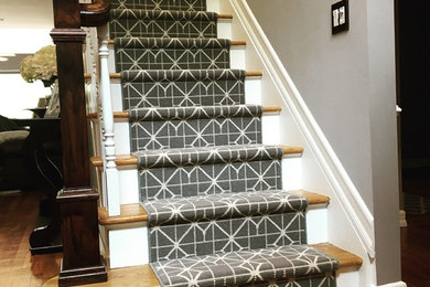 Inspiration for a mid-sized timeless carpeted straight staircase remodel in New York with carpeted risers
