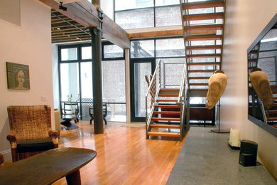 Staircase - large contemporary wooden u-shaped metal railing staircase idea in New York with wooden risers