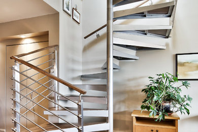 Example of a small trendy wooden spiral open staircase design in Montreal