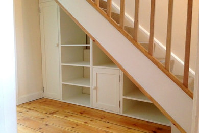 Photo of a contemporary staircase in Other with under stair storage.