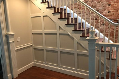 Inspiration for a mid-sized timeless wooden u-shaped wood railing staircase remodel in DC Metro with wooden risers