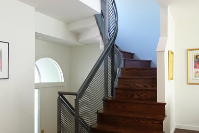 Inspiration for a modern wood curved staircase in Minneapolis with wood risers.
