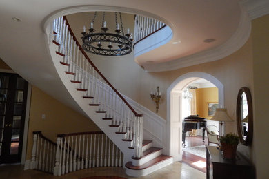 Inspiration for a large timeless wooden spiral staircase remodel in Philadelphia with painted risers