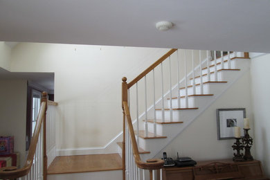 Example of a mid-sized classic wooden l-shaped staircase design in Manchester with painted risers