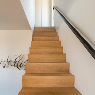 Inspiration for a small wooden l-shaped metal railing staircase remodel with wooden risers