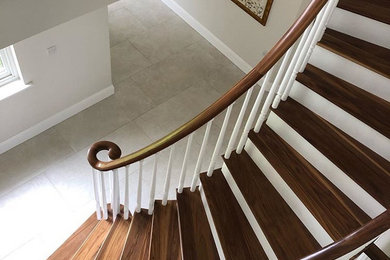 Design ideas for a medium sized traditional wood curved wood railing staircase in Other with painted wood risers.