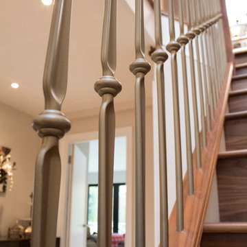 Walnut staircase with gold foged steel spindles and glass
