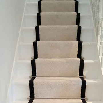 White Carpet With a Black Border to Stairs