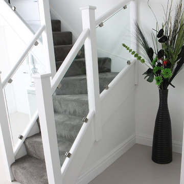 White staircase with clamped glass balustrade