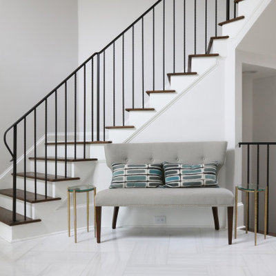 Staircase - large transitional wooden curved metal railing staircase idea in Atlanta with painted risers