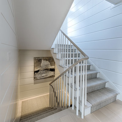 Beach style wooden u-shaped wood railing staircase photo in Boston with painted risers