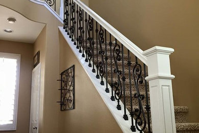 Staircase - large traditional carpeted l-shaped mixed material railing staircase idea in San Diego with carpeted risers