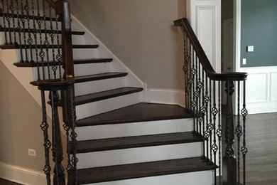 Example of a mid-sized trendy wooden curved wood railing staircase design in Chicago with painted risers