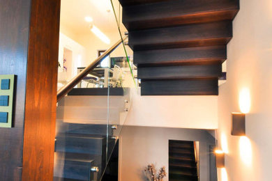Staircase - large modern wooden u-shaped glass railing staircase idea in Miami