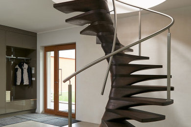 Inspiration for a large modern wooden spiral metal railing staircase remodel in Miami