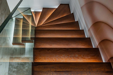 Example of a mid-sized minimalist wooden l-shaped glass railing staircase design in Miami