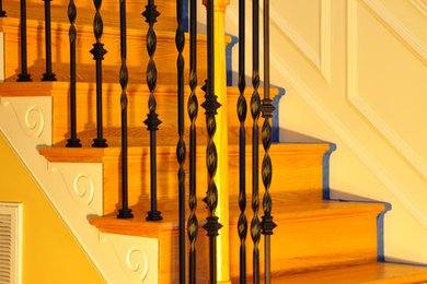 Ejemplo de escalera en L clásica de tamaño medio con escalones de madera, contrahuellas de madera pintada y barandilla de varios materiales