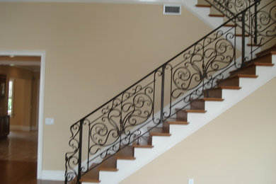 Staircase - mid-sized mediterranean wooden straight staircase idea in Tampa with painted risers