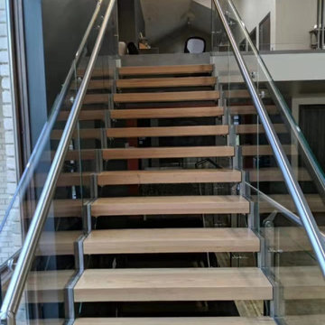 Zigzag staircase with glass railing for a loft