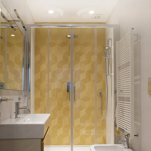 Design ideas for a small contemporary 3/4 bathroom in Milan with flat-panel cabinets, beige cabinets, an alcove shower, a two-piece toilet, yellow tile, terra-cotta tile, white walls, porcelain floors and a trough sink.